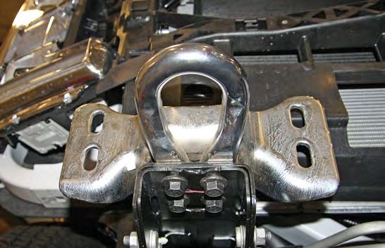 On each side, remove four 18mm (head) bolts and threaded double-nut plate on the backside attaching the bumper to the