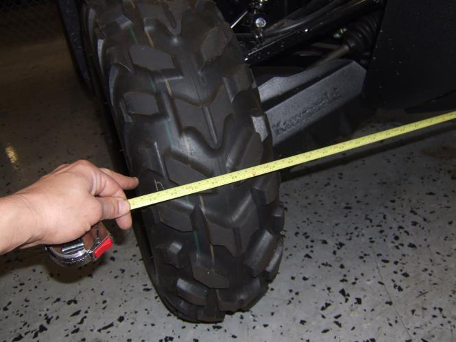 With a tape measure, measure the distance between the 2 front wheels from the same spot on the tread. Measure from the front of the tires and the rear of the tires.