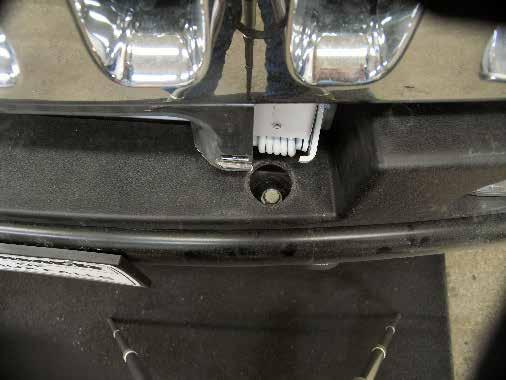 BX4102 3. Using the 18MM socket, remove one metric bolt from the top of the bumper.
