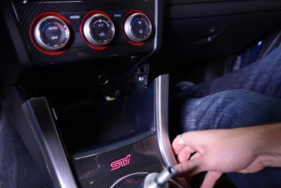 7. CAREFULLY PULL TOWARDS THE BACK OF THE CAR ON THE TOP OF THE SHIFTER SURROUND.
