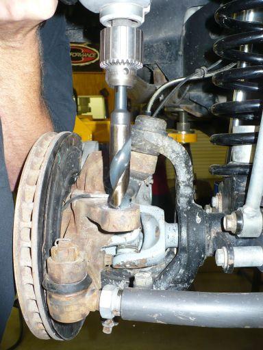 Install the tie rod end to the steering knuckle hole from the top. Use the supplied boot and castle nut.