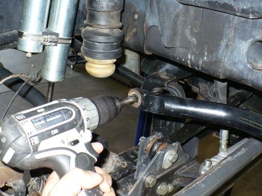 Figure 12-1 Run a 1/2 drill bit or reamer through each side of the stock sway bar holes to enlarge the holes for the new rod end studs.