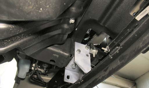 Insert the spacer tube inside the frame end to align with the existing tow hook mount holes.