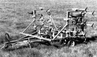 by removing one bolt. This range was adequate to allow fore-and-aft frame levelling with all tractors used during testing. FIGURE 8. Transport Position. nuts, preventing thread damage during tillage.