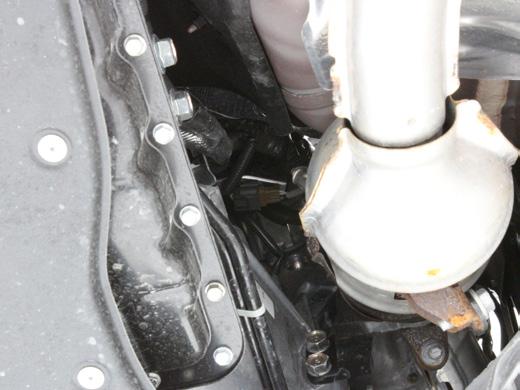You may need to completely unbolt the OEM downpipe first and move it to the side to gain access to the area. The picture below shows the connector on a RWD vehicle. 05.
