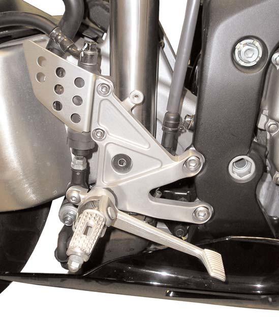 32)Position the exhaust system. First, fully tighten the t-bolt clamp, and then fully tighten both sides of the muffler mounting strap bolt. 33)Reconnect the turn signal and license plate wires.