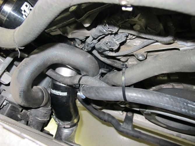 Now is also a good time to use supplied zip ties to secure coolant hose to metal line on front of motor ensuring it will not make contact with