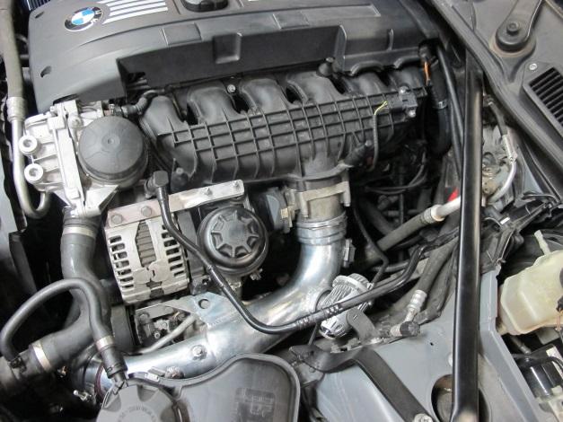 Remove the power steering reservoir (two nuts) and unclip lines from frame rail.