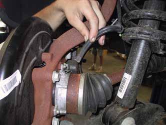 Remove the stock brake line bracket and rubber brake hose. Unbolt the caliper from the spindle but DO NOT let the calipers just hang.