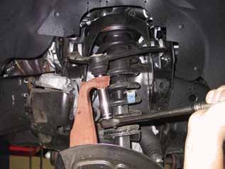 Disassemble the anti-lock brake sensor and the vacuum line from the factory hub. Take off the tie-rod nut & tie-rods from the spindle. Remove the upper and lower ball joints.