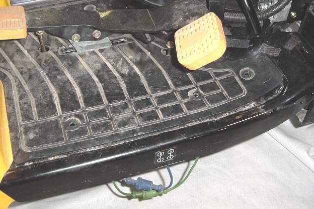 plastic pine tree clips from the rubber mat on top of the floorboard on each side of the tractor.