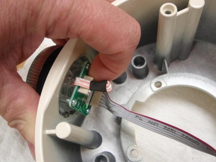 4) Squeeze the tab on the UI wire harness plug to remove it from the electronic control circuit board 7.