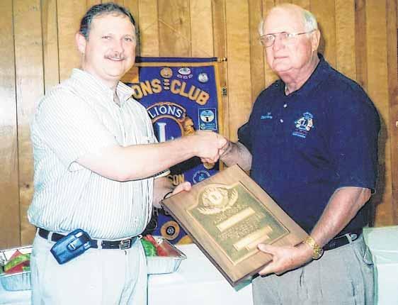 Past District Governor Gene Everette, right, presents the