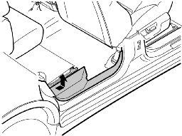 Remove the seat belt from the end mounting. Using a weatherstrip tool, carefully press the locking tab so that the seat belt releases from the end mounting.