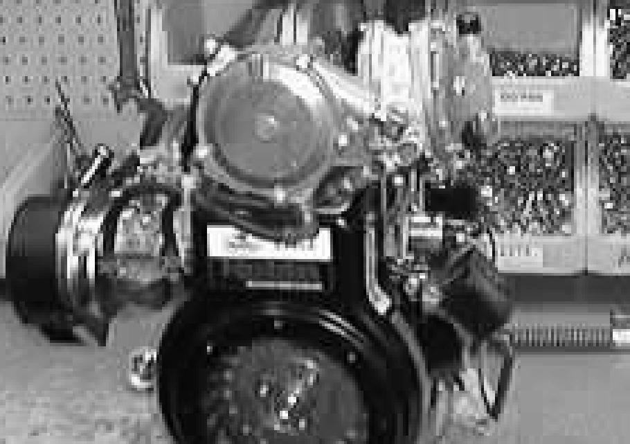ENGINE -GAS/LP 4. Remove the upper attachment bolt from the starter. 5. Go to the rear of the machine and locate the lower attachment bolt from the starter. Remove the bolt. 6.