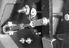 Remove the cotter pin and clevis pin from the end of the main brush lift cable where it attaches to the