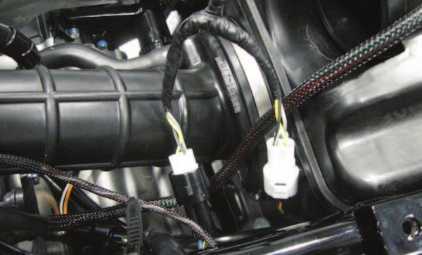 The TPS connectors are located rearward of the injector and on the left hand side of the ATV. This is a set of BLACK 3-pin connectors.