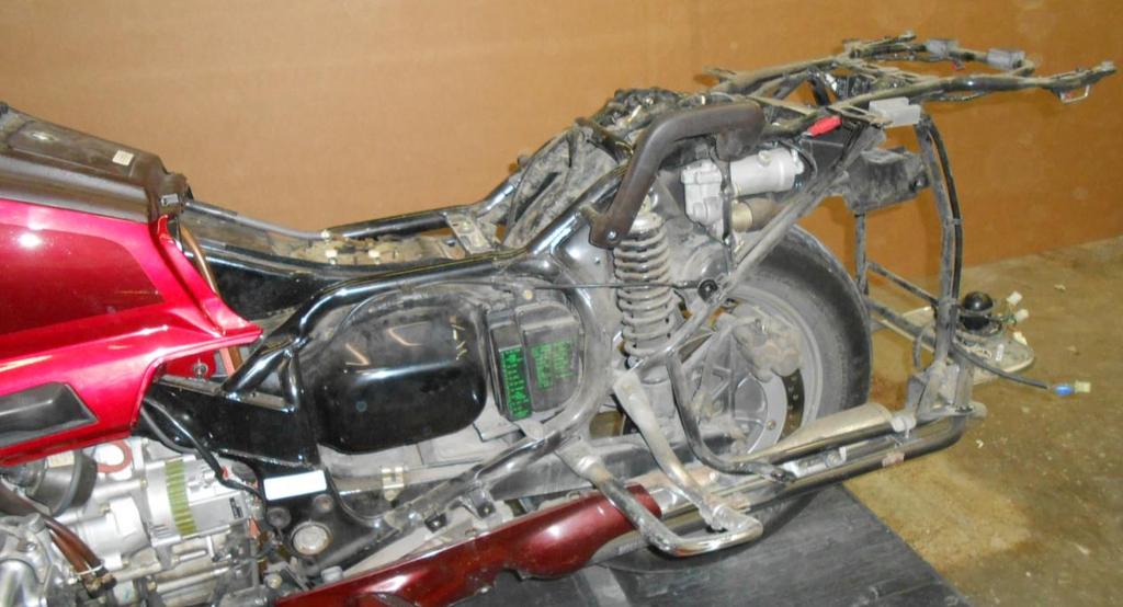 Disassembly of Motorcycle: 1. Place the motorcycle on the center stand or lift. 2. Set the air pressure to zero. 3. Remove the passenger handles and seat. 4 SHCS. 4. Remove the rear side covers. 5.