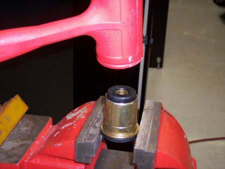 - First, set the bushing (flange down) in a vise. See picture.
