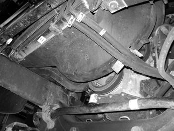 Figure 4b Figure 4c 10. Loosen but do not remove the driver side cab mount bolts. 11. Remove the passenger s side cab bolts.