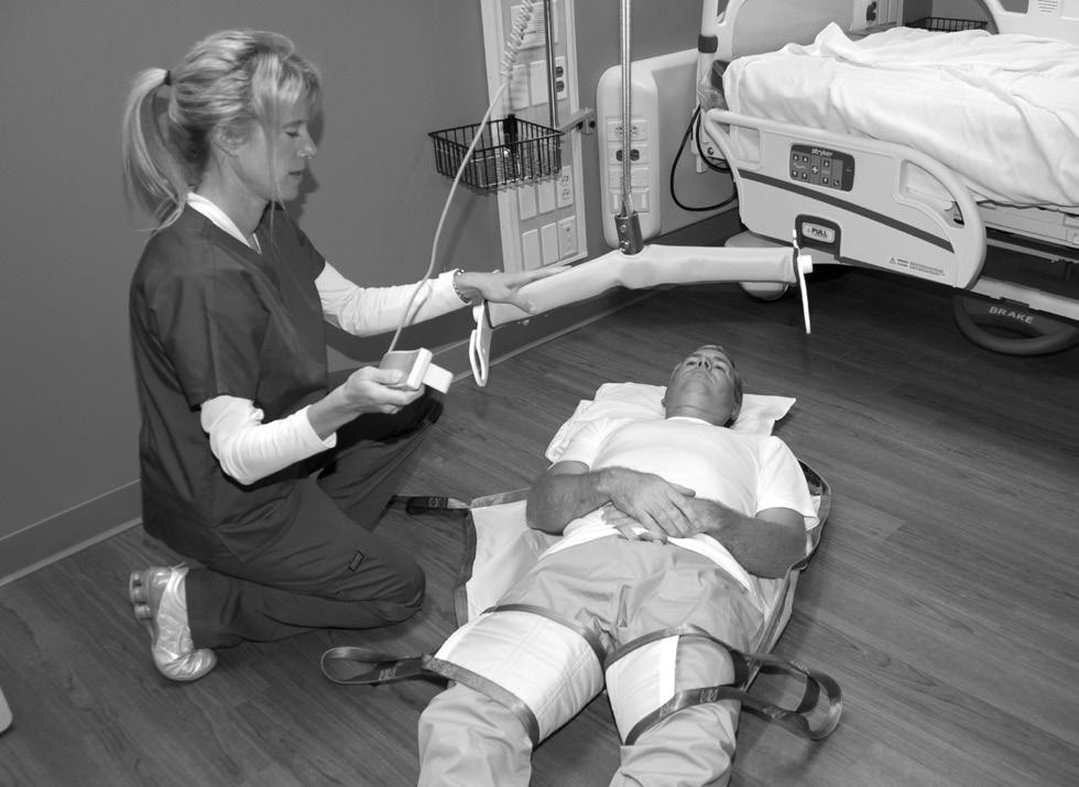 3) Walk with the patient, stabilizing them at the same time to ensure safety. NOTE: Do not use the hand control as a tether for moving the EZ Way Ceiling Lift.