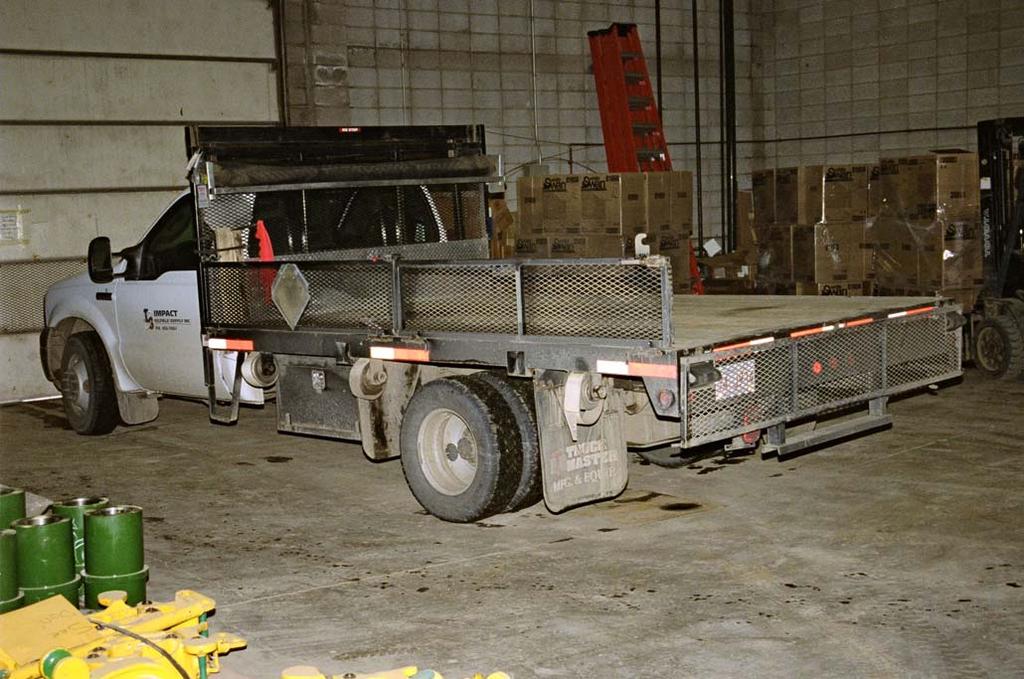 File: 419130 Attachment A Photograph #1 Shows the flatbed truck in the Cando Oilfield Supply & Rentals Ltd.