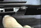 In the top center of the grill is a clip, pull clip forward and up to release. 3.
