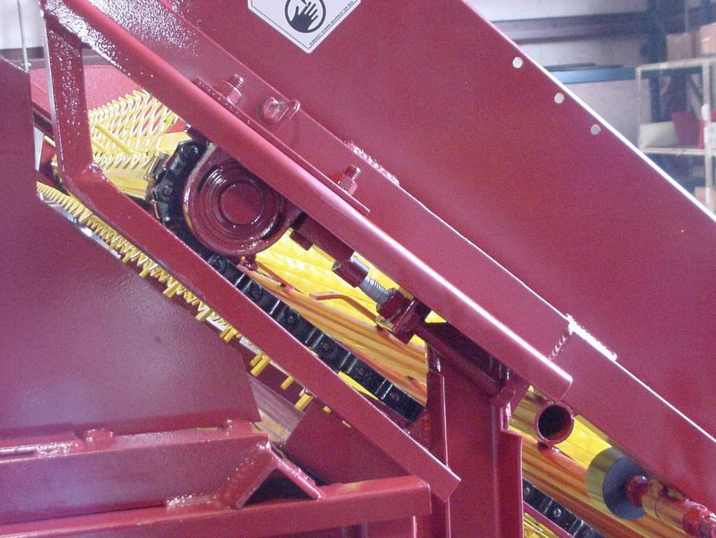 The loading conveyor chain will also need adjusting as it wears. To adjust the tension on the chain, loosen all bolts on the base of the upper loading shaft bearing.