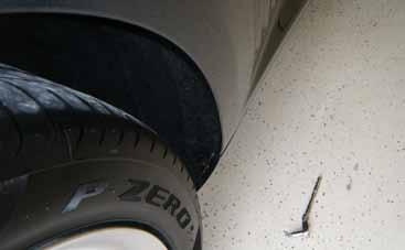 1. Locate the wheel liner securing screw on the passenger rear side of