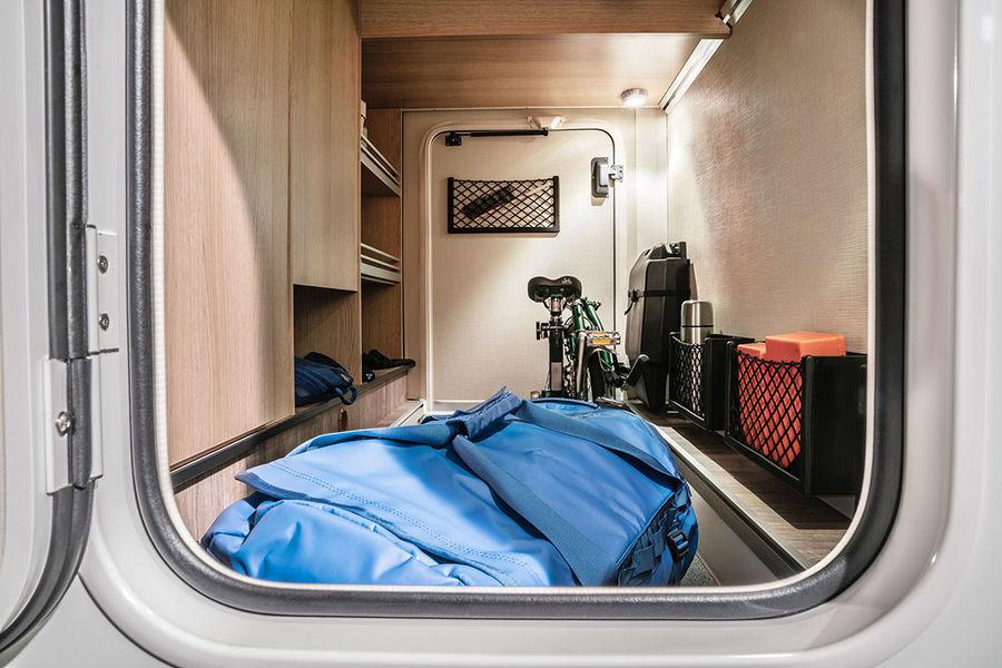 Secured storage compartments and storage nets in the rear garage of the