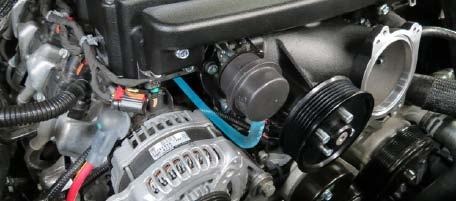 Using a 10mm socket, remove a bolt and nut securing the engine harness