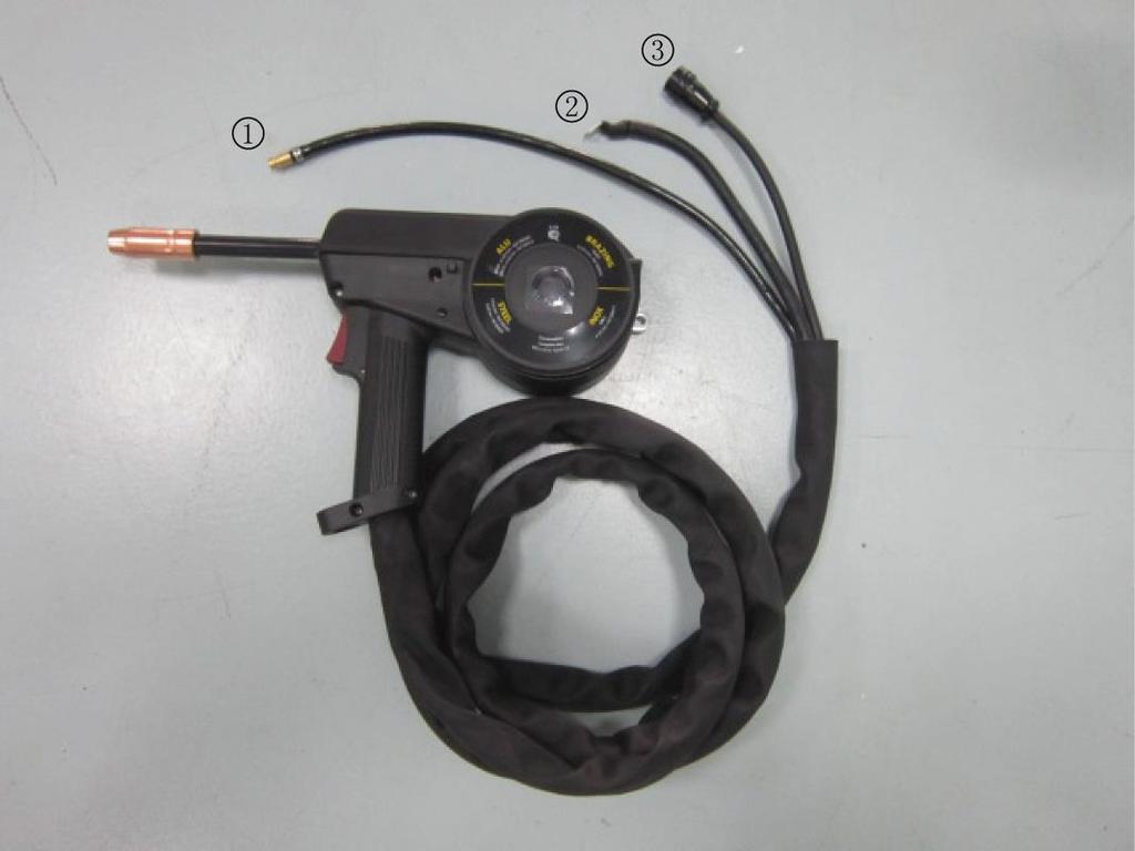 Figure 9 3. We recommend removing the MIG torch when the Spool Gun is connected to avoid accidental arcing. Loosen the wing nut retaining bolt and slide the MIG torch out of the front of the machine.