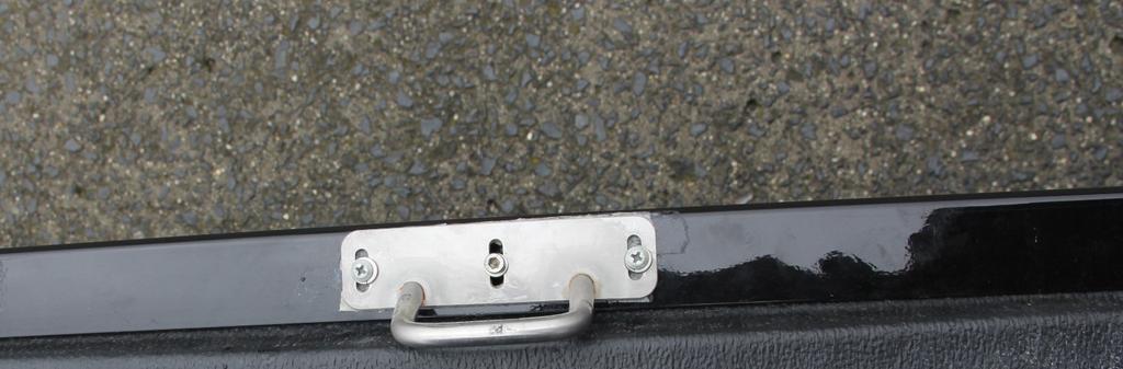 Align the center hole of the latch with the top of the center of the tailgate, making sure the bottom of the latch is facing down.