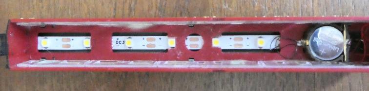 However, the lights are then visible when viewed from track level, so I prefer to put the strip above the false roof in the gap, and they light the coach better.