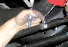 (See Photo # 22) 29. Attach the new steering stabilizer bracket to the crossmember in the factory mounting holes using the factory hardware. Install the bolts from the front. Torque to 90 Ft. Lbs. 30.