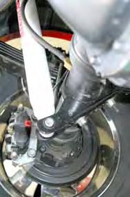 (See Photo #1) Loosen the u-bolt that attaches the bracket to the axle.