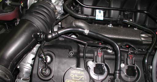 release the two ball and socket pins from the intake and remove the engine cover from the vehicle.