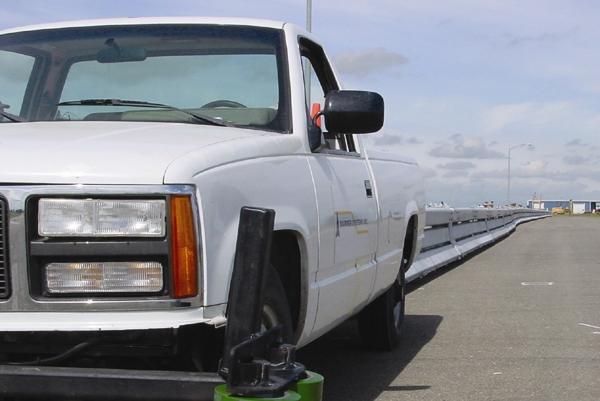 Attach the length of link barrier to a truck using a chain or a hinge pin as show above. Use caution when moving sections on a slope or on the crown of a roadway.