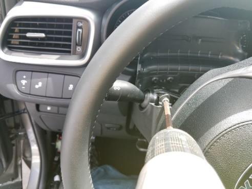Turn steering wheel to left side. Using a Phillips screwdriver remove screw.