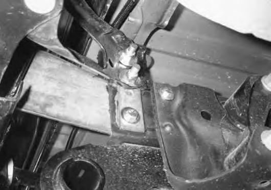 101. Lift the bumper into position on the vehicle and fasten in place with new 3/8" x 1-1/2" bolts, nuts and washers through the forward-most hole in the bracket that runs through the factory spring