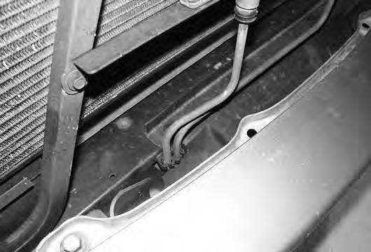 If equipped, remove the radiator hose clip that is attached to the middle of the air intake tube. Remove the intake tube from the vehicle. 7.