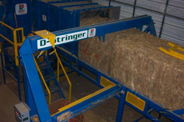 Twine removal hooks on D-Stringer D-Stringer A cutter and a set of hooks remove twine from bales