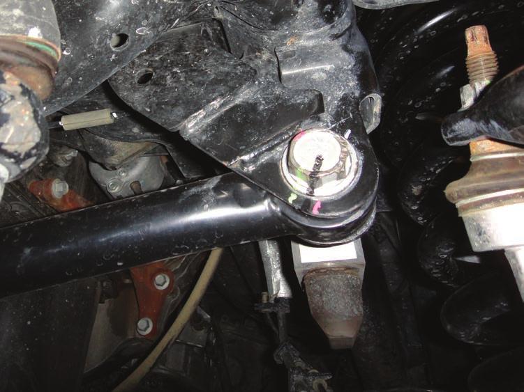 4. Remove the upper track bar bolt from the frame using a 27mm socket/wrench. Use caution as the truck may shift when the bolt is removed. [FIGURE 3] FIG.3 5.