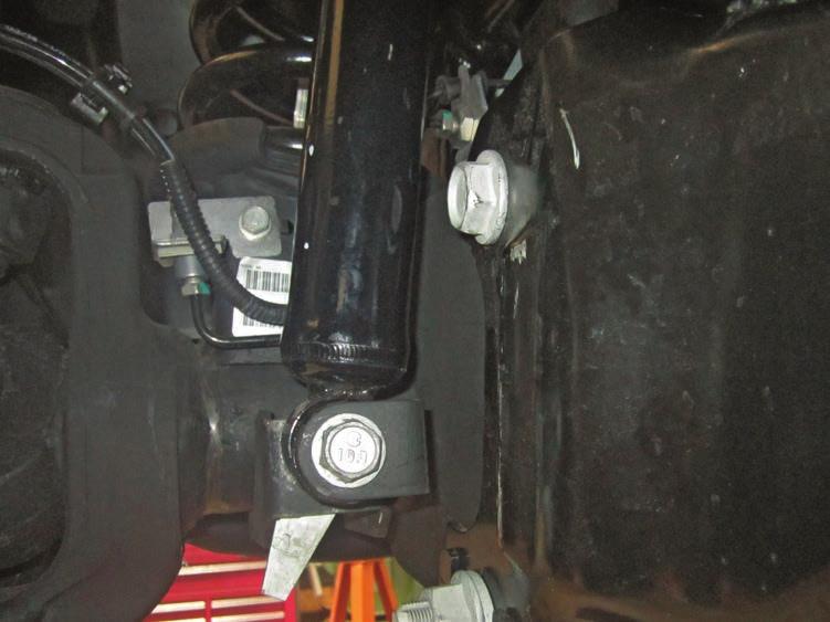 Ensure the jack stands are secure and set properly before lowering the jack. NEVER WORK UNDER AN UNSUPPORTED VEHICLE. Remove the front wheels. 6. Support the axle housing with a heavy duty jack.