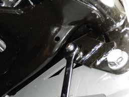 Place something firm between the crossmember and oil pan to prevent damage.