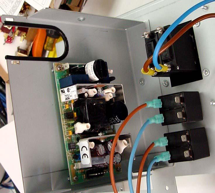 12. Remove the power supply bracket by cutting the cable ties and removing the two 8-32 screws from the front side of the Power Distribution assembly and save for later use.