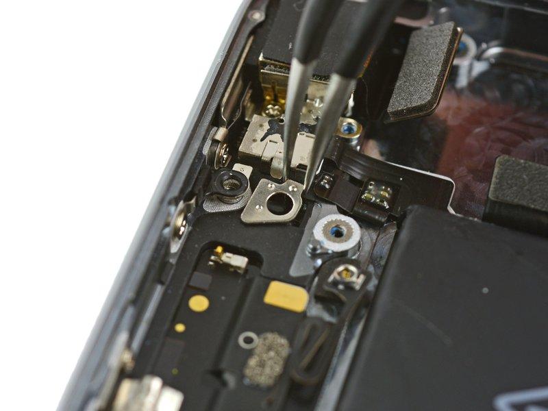 phone. Use tweezers to remove the plate from beneath the bracket to the left of the rear-facing camera.