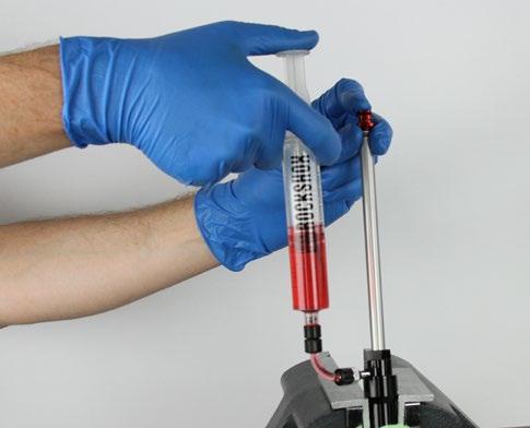 Keep pressure on the plunger as the syringe fills with oil.