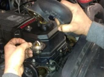 STEP 3: Using an 8mm Socket, remove the three bolts anchoring the stock thermostat housing.