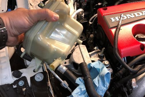 Be prepared to catch the small amount of coolant that may leak out.